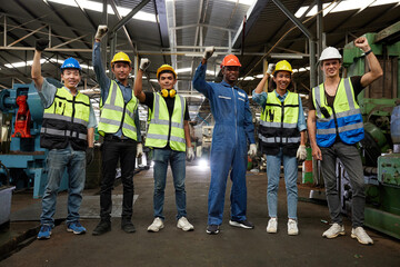 groups of workers or engineers raise hands for success work and project in the factory