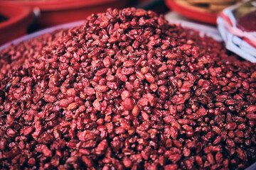 Heap of dry barberries on a market stall