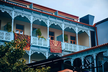 Colorful carpets hanging on balconies of restored traditional house in Old Town of Tbilisi, Georgia