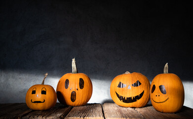scary funny Halloween pumpkins on wooden table