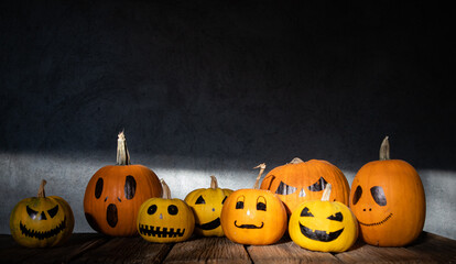 scary funny Halloween pumpkins on wooden table