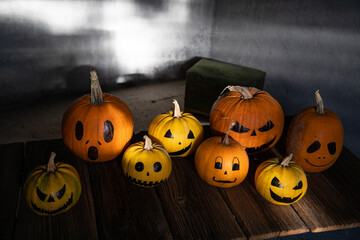 scary funny Halloween pumpkins on wooden table