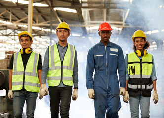 portrait group of engineers or workers standing and walking in the factory