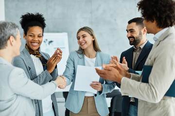 young business people meeting office handshake hand shake shaking hands teamwork group contract...