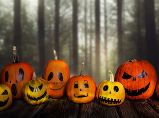 scary funny Halloween pumpkins on wooden table