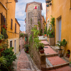 Fototapeta na wymiar Colorful cosy street and houses in the Old Town of Menton, French Riviera, France