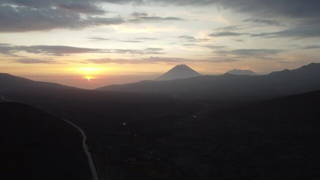 Camera panning up to the sunset behind Chachani volcano Peru in the distance