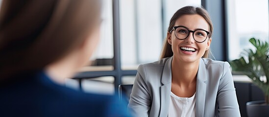 Joyful hiring manager interviewing job candidate in office Cheerful businesswoman meeting shortlisted applicant in creative workplace With copyspace for text