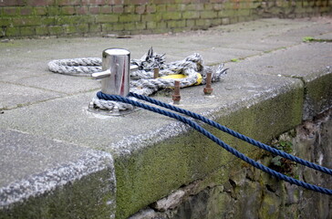 Thick hemp rope on the pier in the seaport.