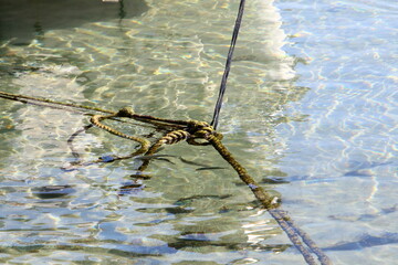 Thick hemp rope on the pier in the seaport.