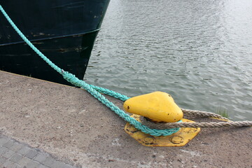 Thick hemp rope on the pier in the seaport.