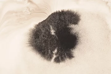 Tuinposter Black brown Ink watercolor spray blot on beige grain texture paper background. © Liliia