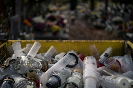 Discarded grave candles and refills in trash after All Saints' Day November 1, Poland