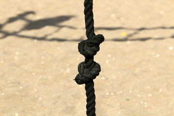Thick hemp rope on the pier in the seaport.