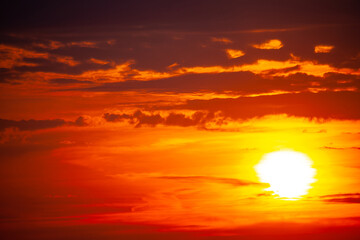 Bright orange sunset with dark clouds on the sky