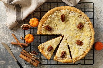 Thanksgiving dessert. Fall traditional pie pumpkin with crumble and pecan on a gray stone...