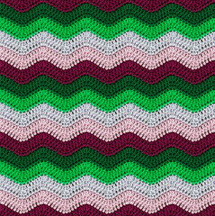 Seamless knitted pattern in the form of zigzags crocheted with threads of contrasting colors. Cotton yarn. African style.