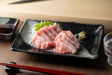 blue fin fatty tuna with japanese sushi knife