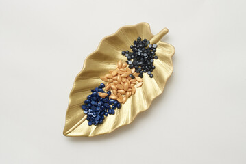 Granulated depilatory wax top view on a plate in the shape of a plant leaf