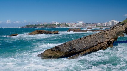 Waves breaking on rocks in Biarritz - 658802611
