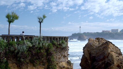 Biarritz beach with La Roche Percée rock and lighthouse in the background - 658802626