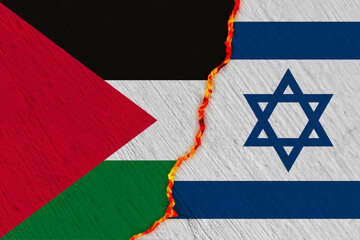 Israeli and Palestinian flags on the broken wall with flames visible behind it