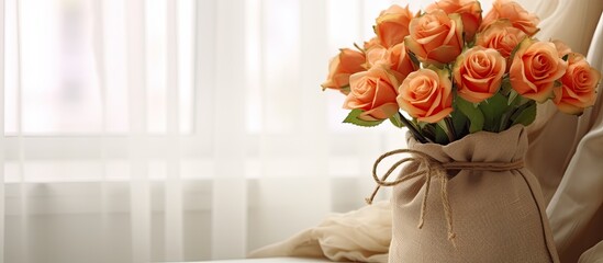 Vintage style small sack containing fake orange roses located in the living room With copyspace for text