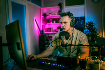 Young man male gamer playing computer game streaming video losing