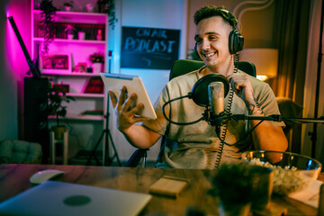 man shooting or streaming video podcast or vlogg blogger at studio