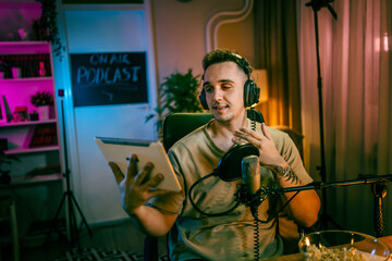man shooting or streaming video podcast or vlogg blogger at studio