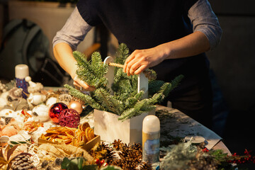 Making Christmas wreath with natural fir branches for advent. Christmas decorating ideas and hand...