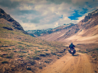 Vintage retro effect filtered hipster style image of motorcycle bike on mountain road in Himalayas. Spiti Valley, Himachal Pradesh, India