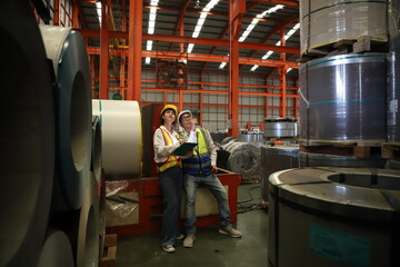 worker or engineer working in factory with safety uniform , safety hat and safety glasses , image is safety concept or happy workplace