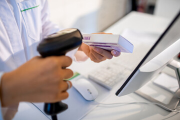 Close up of a pharmacist scanning a bar code at the pharmacy