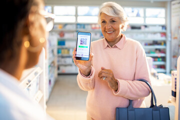 Senior woman showing her vaccine certificate to a pharmacist at the pharmacy