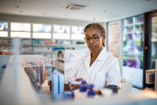 Senior female pharmacist going over inventory in a pharmacy
