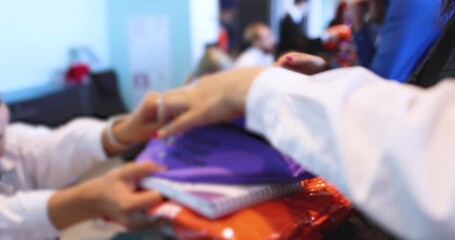 Process of checking in on a conference congress forum event, registration desk table, visitors and attendees receiving a name badge and entrance wristband bracelet and register electronic ticket
