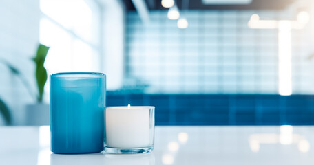 Abstract blur contemporary interior bathroom in blue color background with white marble table with aroma candles for show, promote and design content or product on display concept - obrazy, fototapety, plakaty