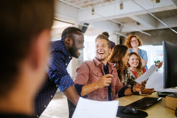 Diverse group of coworkers working together on a project in the office of a startup company