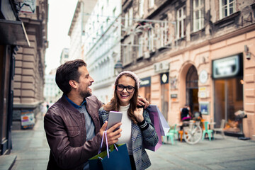 Attractive young couple walking and shopping in the city