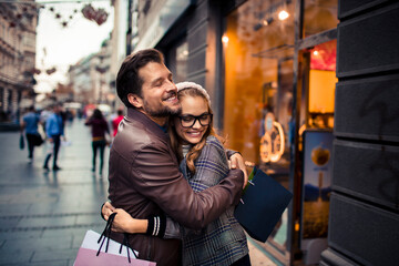 Attractive young couple walking and shopping in the city