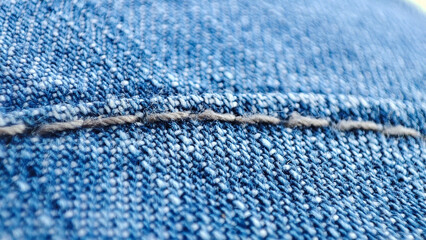 Blue jeans, closeup of the denim material texture. Detailed macro