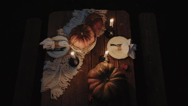 Incredible atmosphere at night in the forest. A beautifully decorated and set table for Halloween. A good concept for Halloween night. View from above. 