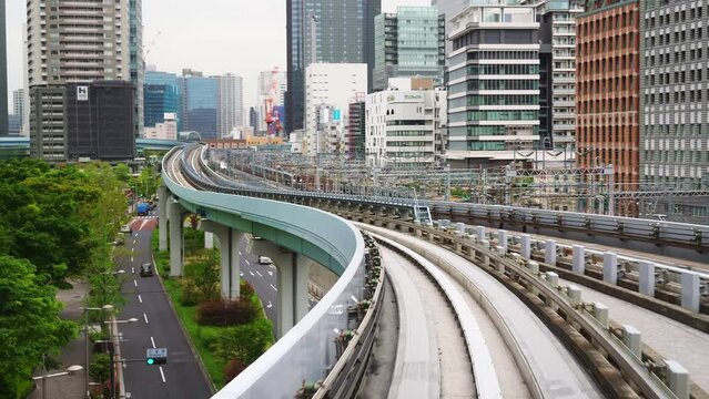 Tokyo train line, automated transit between Shimbashi to Toyosu, via Odaiba across the Rainbow Bridge. monorail train in modern urban center.