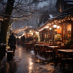 Fototapeta premium view of the town in winter with snow, warm bright cafes