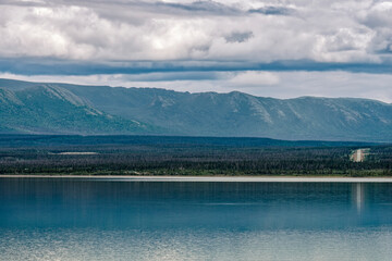 The Alaska Highway is visible across the waters of Kluane Lake in the Yukon Territory, Canada
