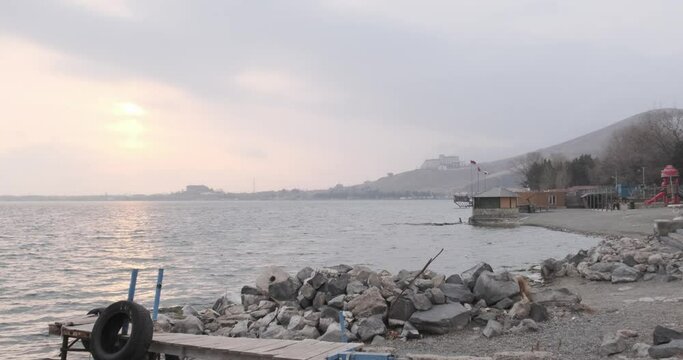 Discover the breathtaking beauty of Armenia's Lake Sevan, surrounded by snow-covered mountains, in the tranquil embrace of winter