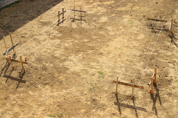 laying out the shape of a rectangular building on the ground with profile boards