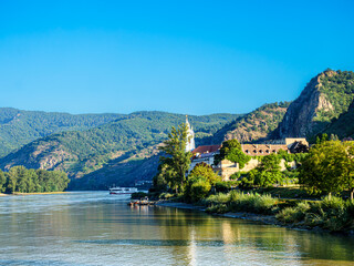 Fototapeta premium Downstream Church with River Cruiser