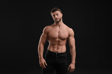 Handsome muscular man on black background. Sexy body